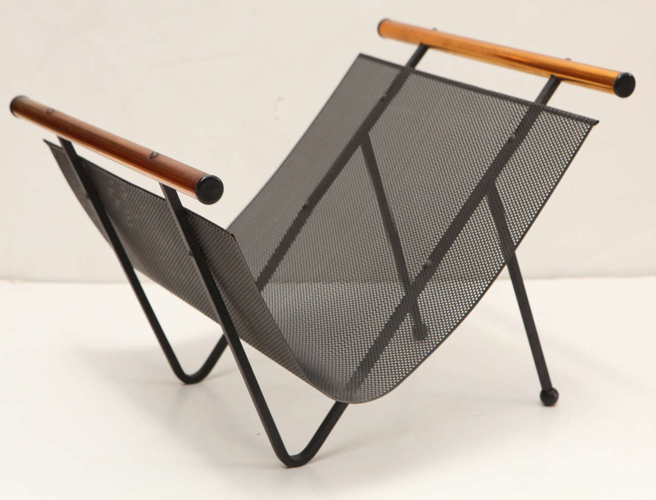 Scandinavian magazine rack with metal and copper frame.