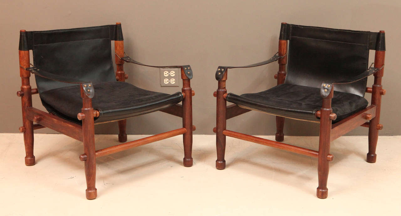 Pair of black leather and rosewood Scandinavian safari chairs.