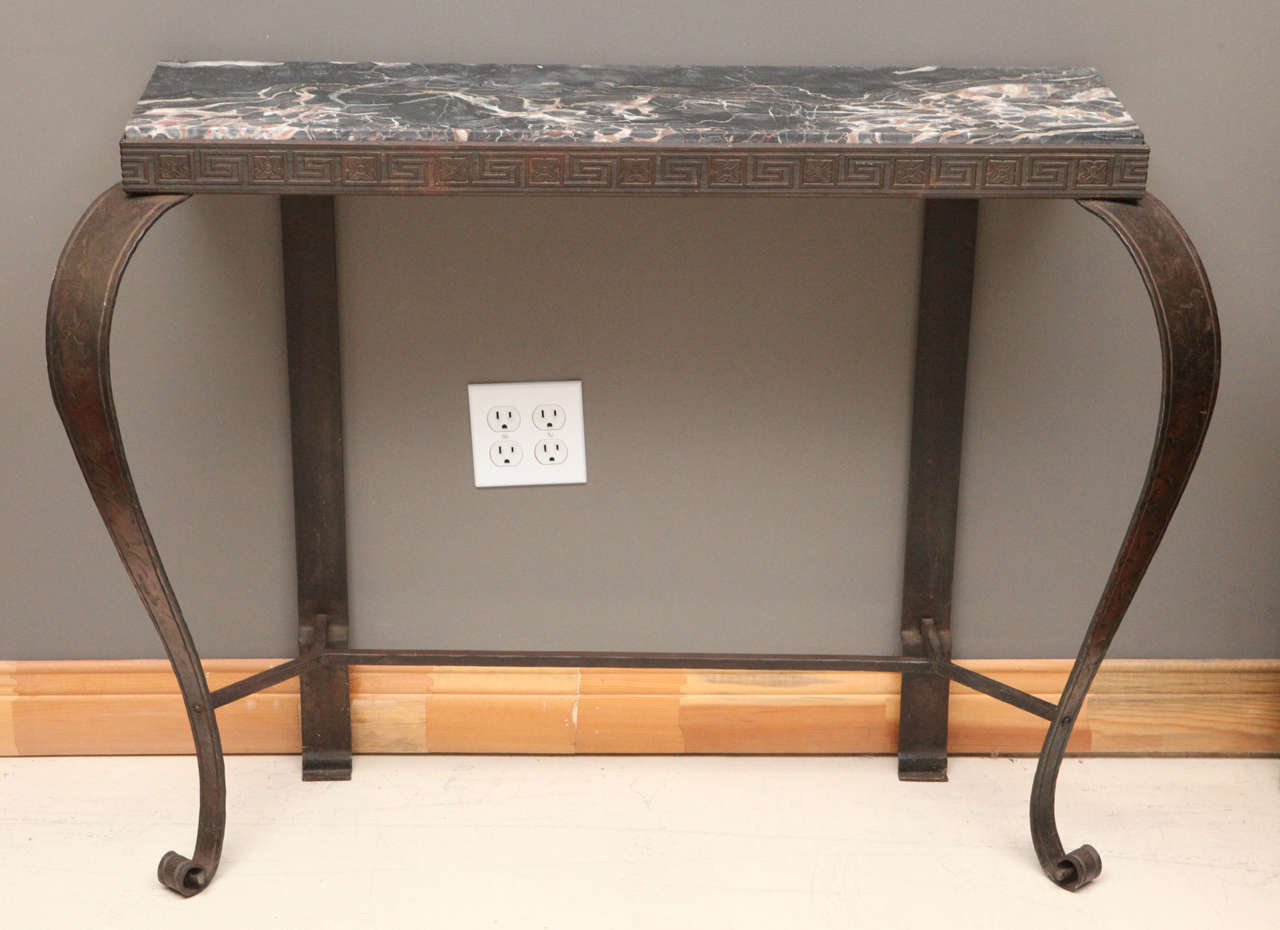 Iron and marble console table with charming Grecian details.