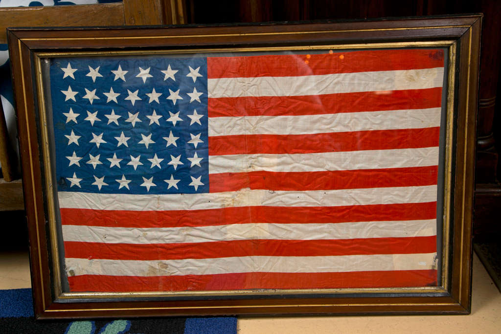 Wood framed Division Flag from the  end of the Civil War. . Torn and
tattered polished cotton- Appears to be used by a military unit,
36 star frag was issued for Nevada's admission to the  Union on 
October 31, 1864, 