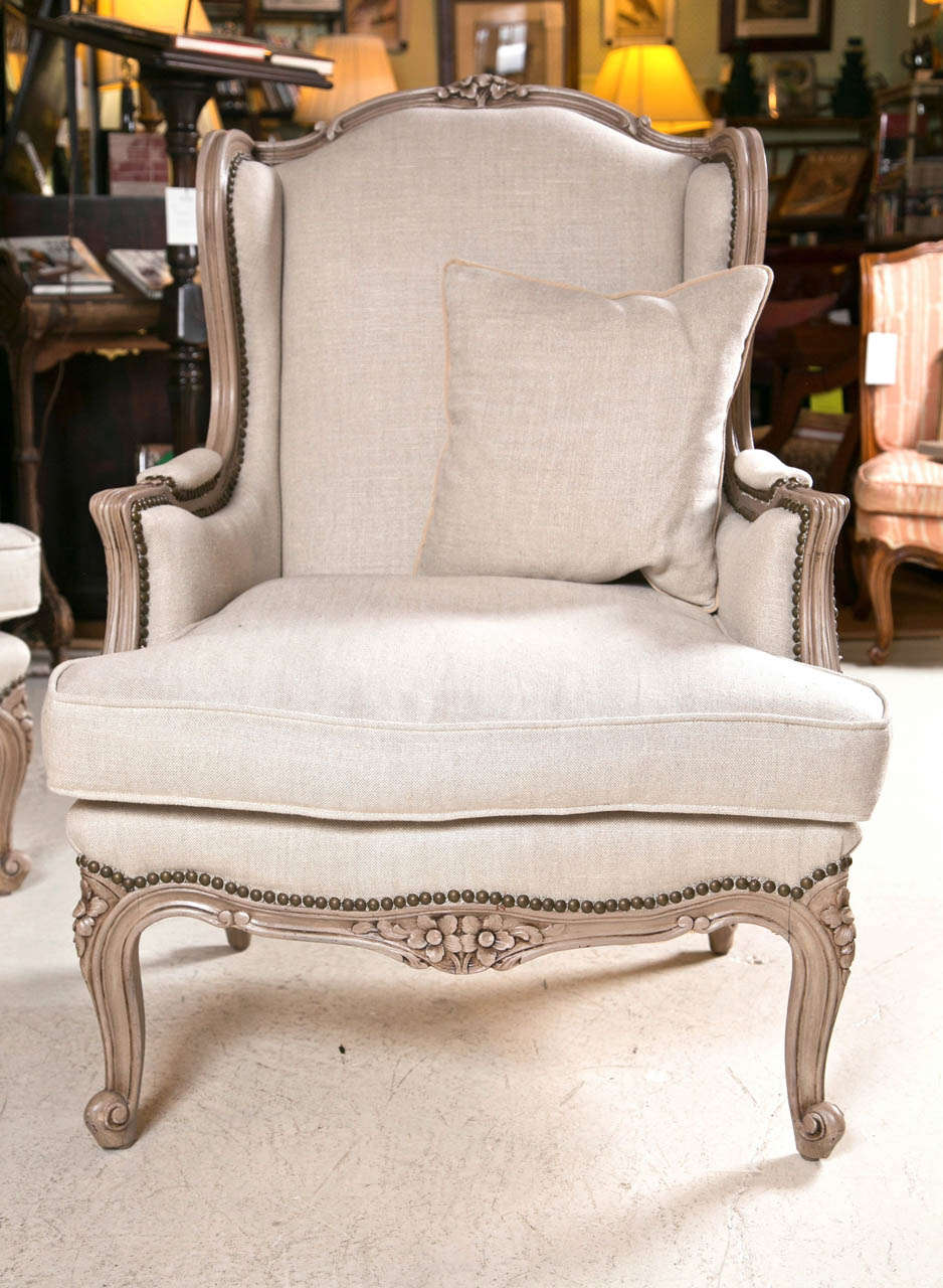 Pair of French Wingback Chairs In Linen Upholstery with Nail Heads and down filled cushions