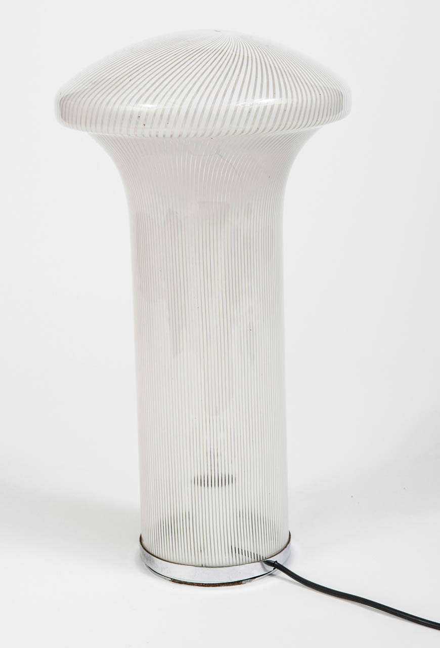 A rare Murano Glass Lamp of organic mushroom form.  Opaque white striped glass.  Mounted on a chrome base.  Italy, Circa 1960.

58 x 32 cm diameter