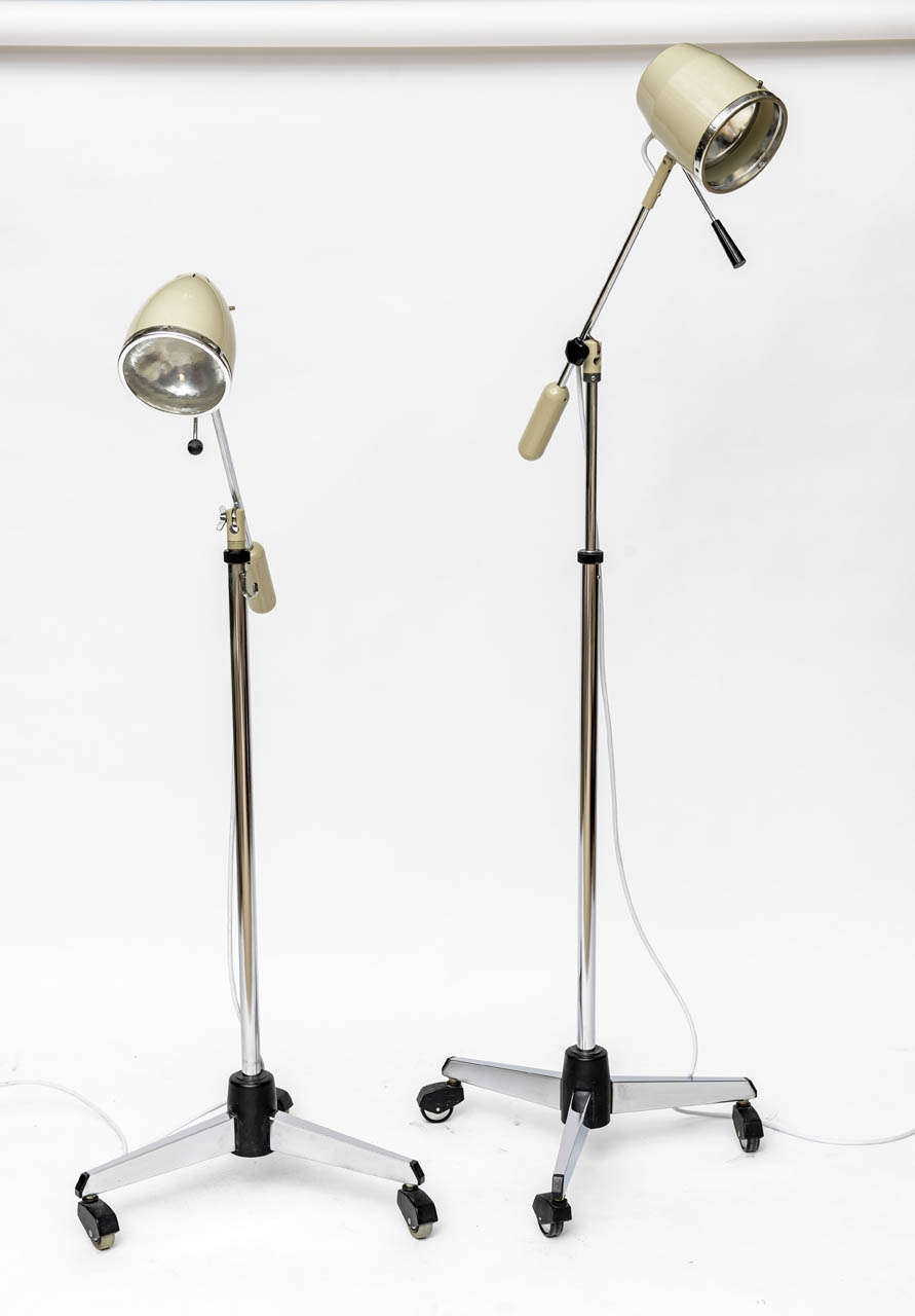 Mid Century German medical lamps with enameled metal shades ( mellowed from a clinical white to a warm cream ), and mottled glass diffusers. These newly re-wired, chrome-based beauties can be turned, swiveled, and adjusted up and down to stylishly