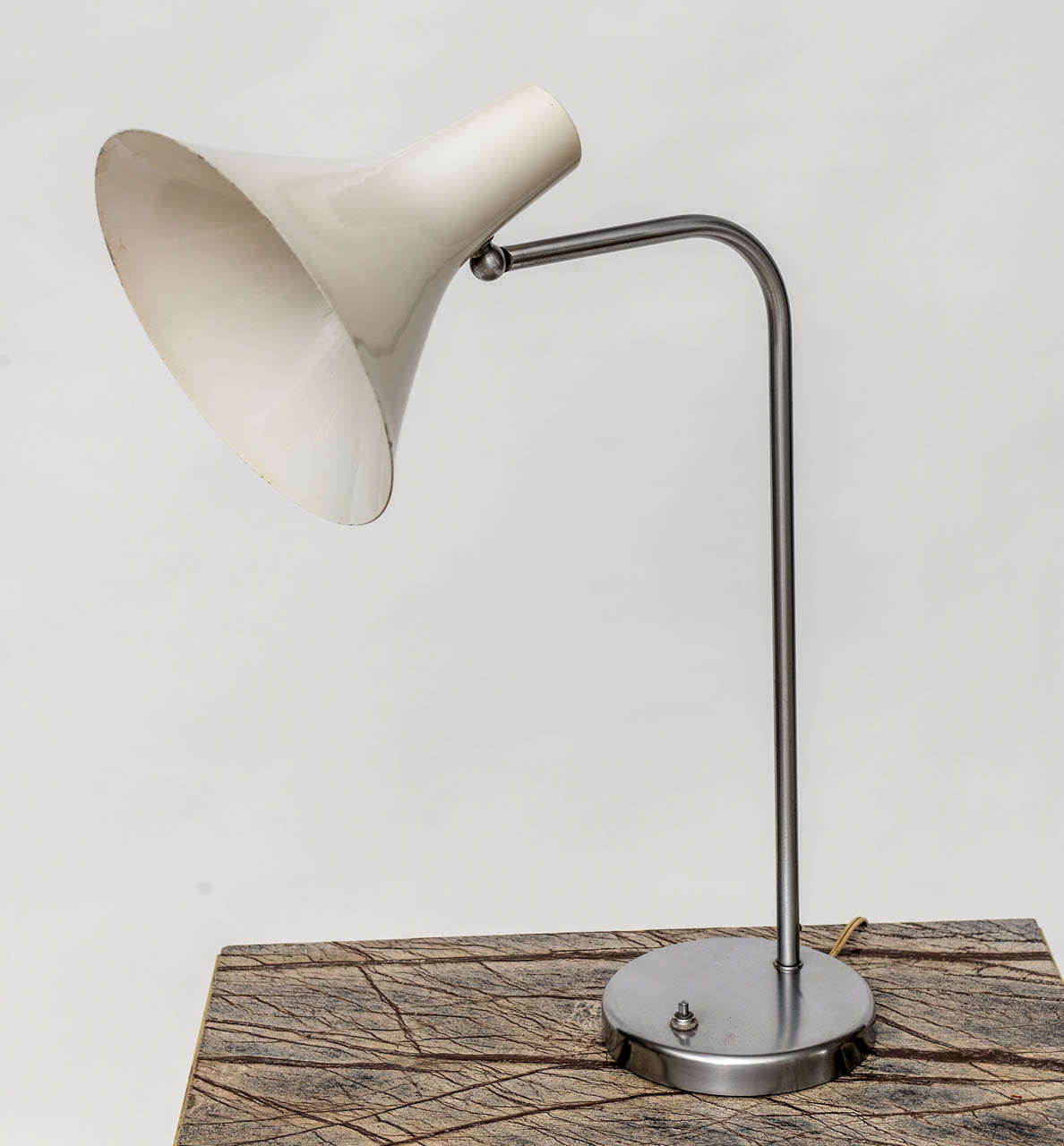 Perfect in their simplicity, these 1960's task lamps by Nessen Studios feature pivoting white enameled shades (aged to a soft off-white) on brushed nickel bases. Rare to find in such good original condition. Please note that these lamps are sold