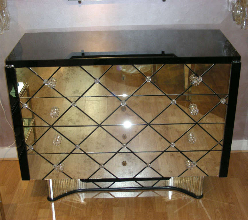 Art deco commode all in mirror with four drawers .