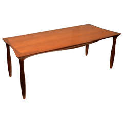 Vintage An elegant curved line coffee table in teck. Circa 1960.