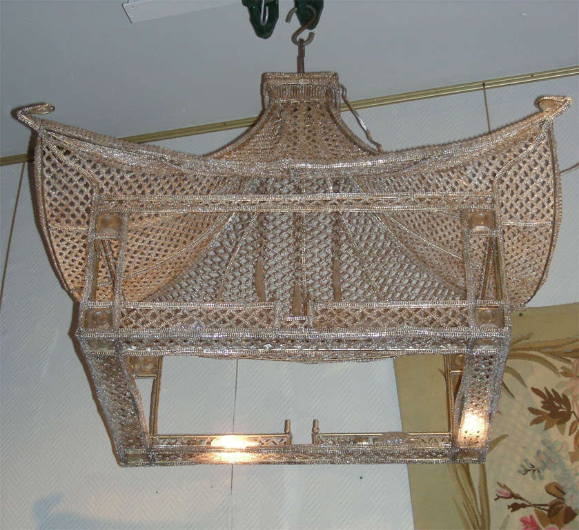 Two 1960s pagoda-shaped chandeliers with glass pearls; eight lights.