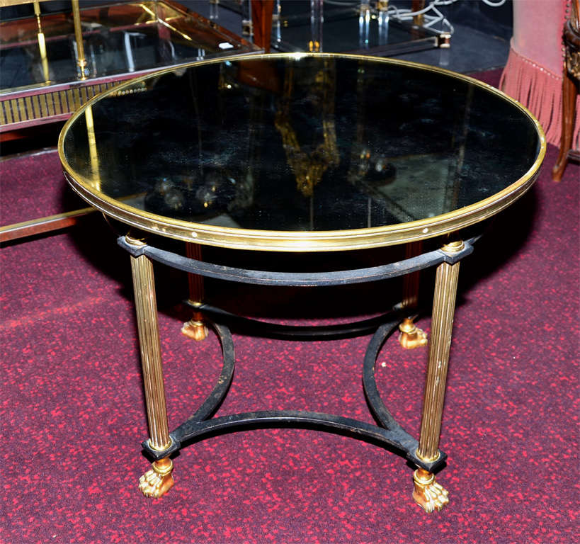 1970's coffee table in the style of Maison Jansen, in bronze and wrought iron; clawed feet, oxidized mirror top surface representing clouds.