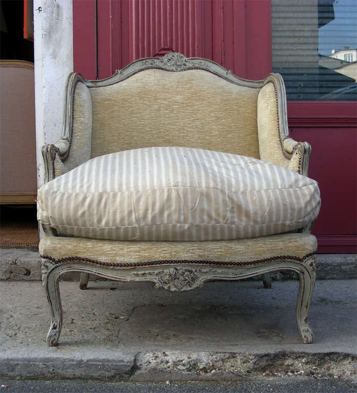 Large 1900-1920 Louis XV style winged armchair in gray patina wood.