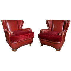 A Pair of Red Leather Armchairs