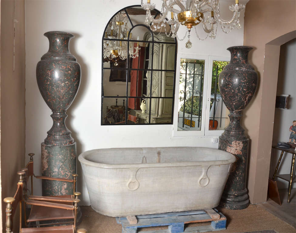 Marble tub one face whis ring back near wall
