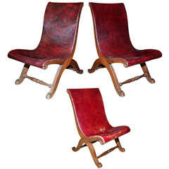 A pair of gondole chairs and a third baby one