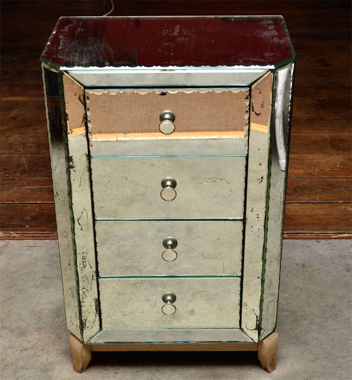 Esquisite small mirror-covered commode.
