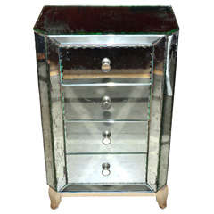 Esquisite small mirror-covered commode.