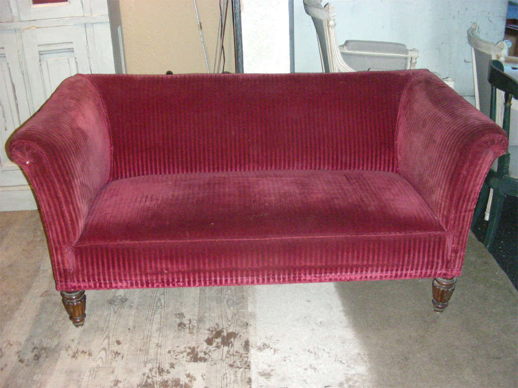 End of 19th century small sofa, with rosewood legs. To be reupholstered.