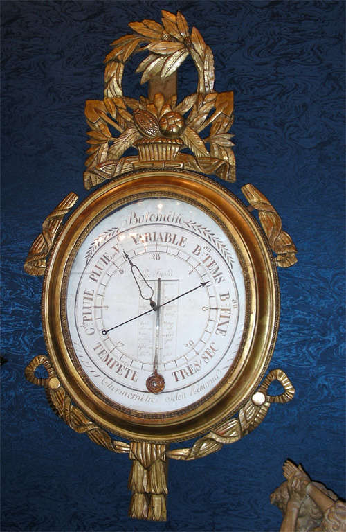 18th century Louis XVI period barometer, framed in carved and gilded wood with a basket of fruit, leaves and swags. In working condition.