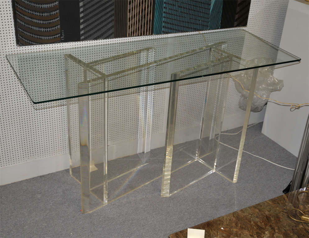 1970s console table with plexiglass base and glass top.