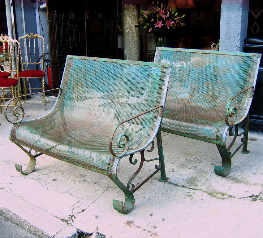 Two 1950s iron benches in their original green patina.