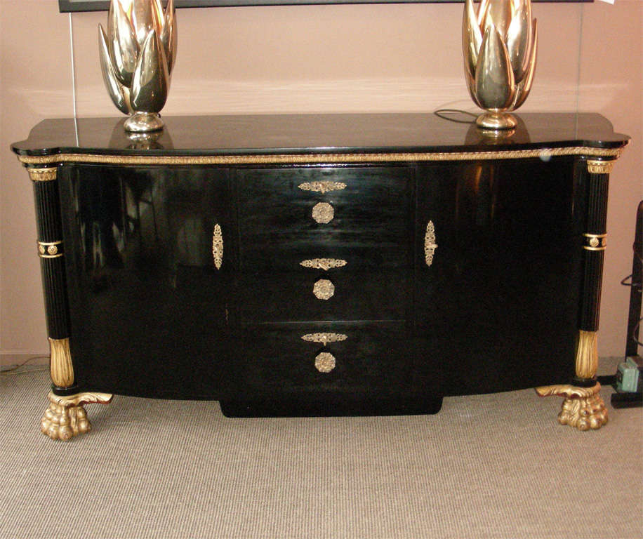 1940s Italian black lacquered commode, in neo-classical style, with gilt wood fittings. Interior is in gnarled maple. Three drawers in the center, and two doors on the sides.