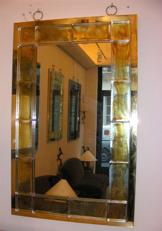 Andre Hayat mirror with thick gold cloudy brick glass frame surrounded by a gold bronze metal frame a two hanging ring.