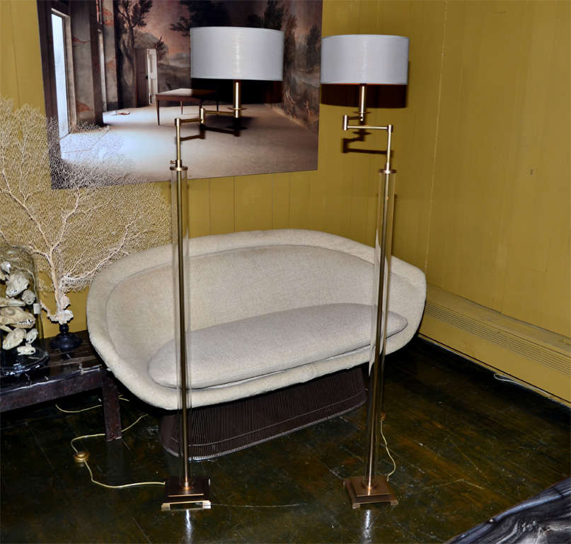 Reading floorlamps with adjustable arm. Iron double base and glass tube. Coton shades linened with gold inside.