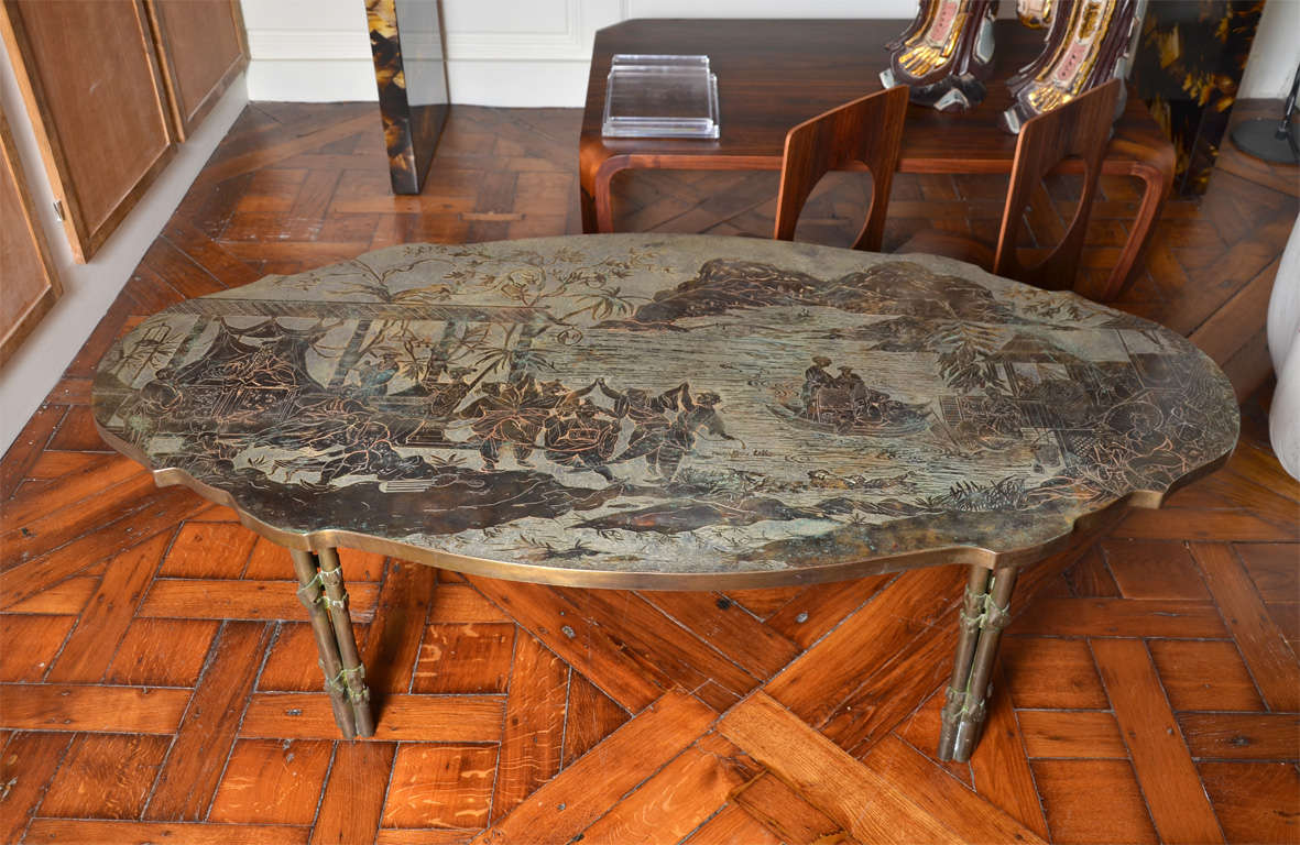one of finest philip and Kelvin Laverne's coffee tables.
The acid etched design pewter bronze oval edged shaped top  representiing a landscape with  A dignitary in a summer pavillion watching dancers and musicians ,  mountains surrounding a lake