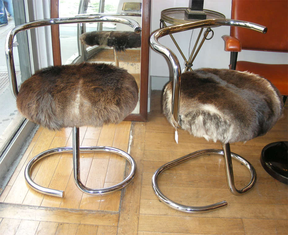 Two 1970s armchairs with structure in chrome metal and seating covered in fur.