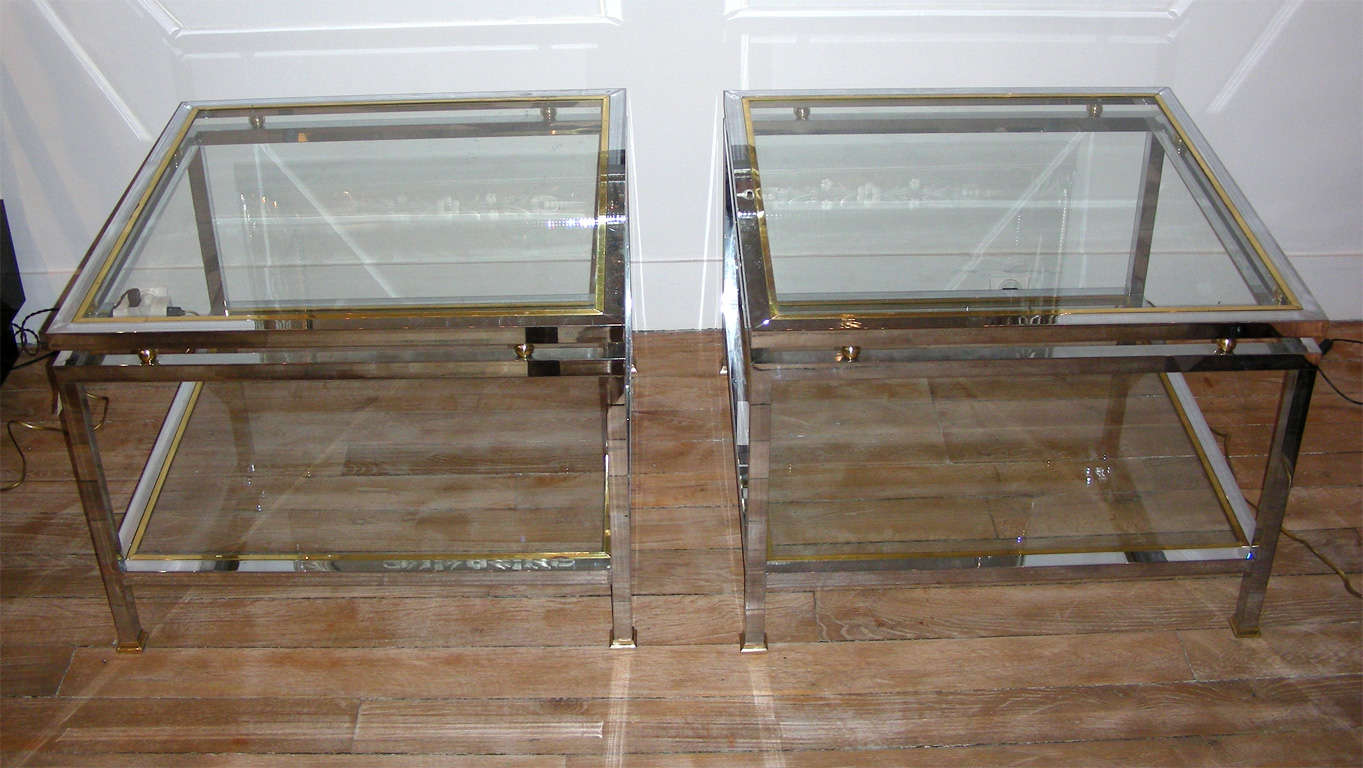 A pair of two-tiered end tables in chromed metal