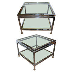 A pair of two-tiered end tables in chromed metal