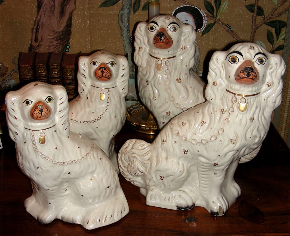 Two big and two smaller ceramic dogs from Staffordshire potteries. The smaller dogs measure 25cm in height, 20 cm in length and 13 cm in diameter.