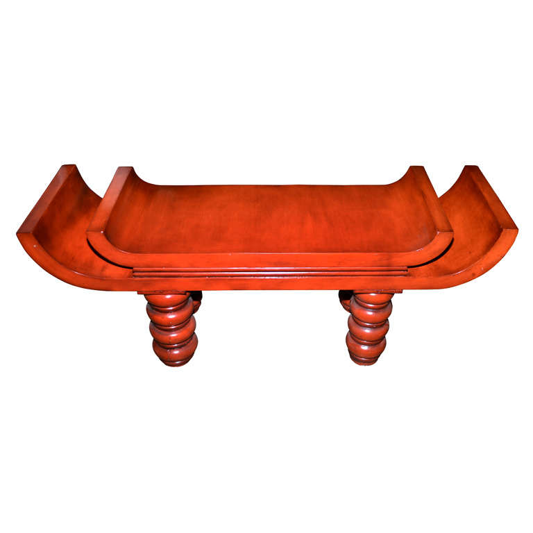 An unusual red lacquered  bench in the style of Tony Duquette .