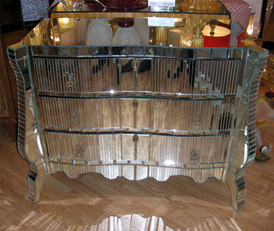 Unusual work of mirror for this commode .