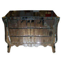 Unusual work of mirror for this commode .