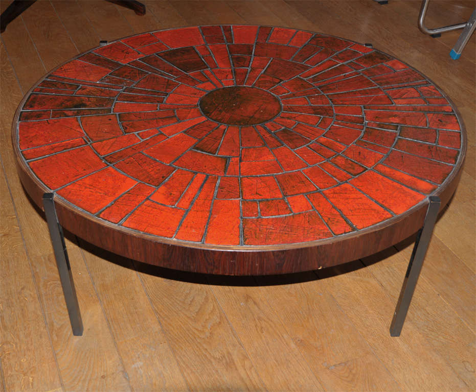A one-off coffee table by the Belgian artist Rogier Vandeweghe (°1923) and executed by his own ceramic workshop located in Bruges (BE). 
Top made of hand-formed tiles with a chromium red glaze. The firing of this specific color required a very