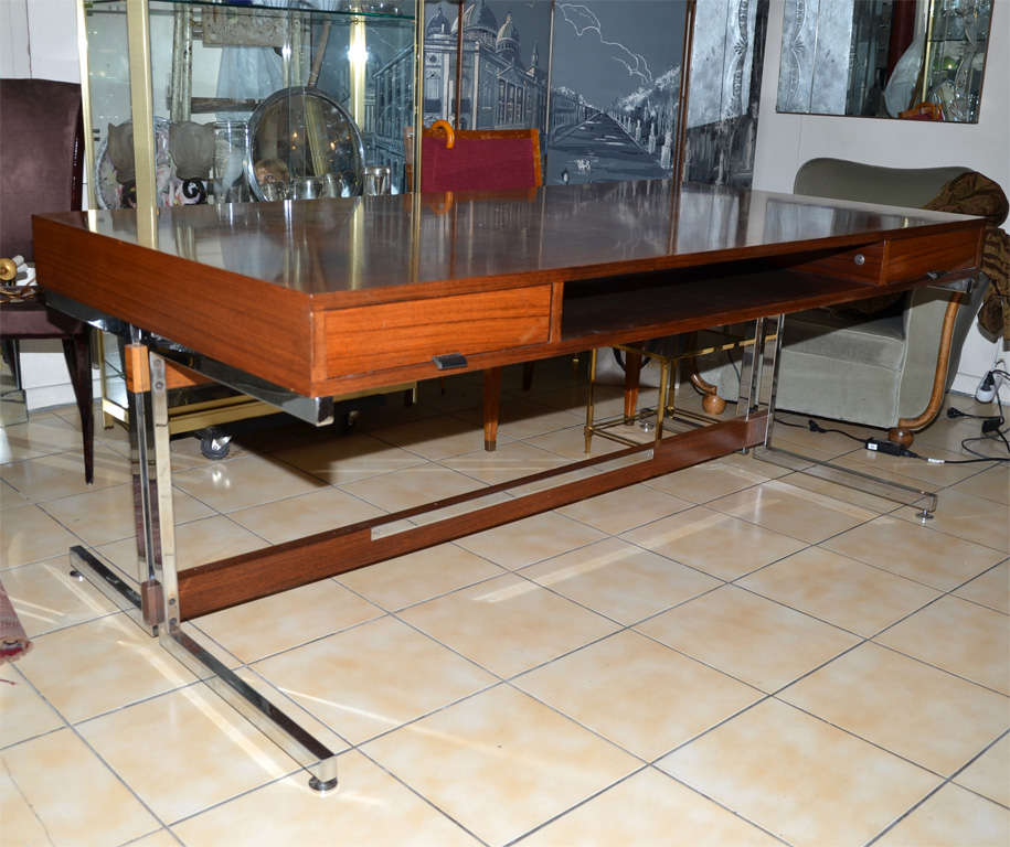 Large 1960s desk by Florence Knoll in palmwood and chromed metal. Double face: one side has two drawers with leather pulls and central open rack; other side has large rack. Possibly the personal desk of Florence Knoll.