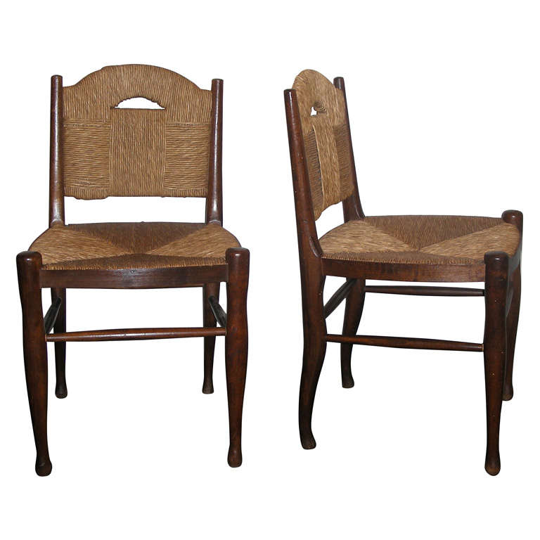 Pair of  wood and rush chairs by  J.E. Ruhlmann.