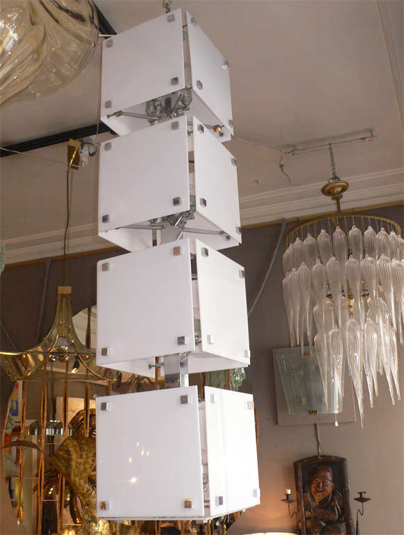 Two 1060-1970 Italian chandeliers in the style of Gaetano Sciolari, with structure in chrome metal, and segments of white plexiglass. 16 lights per chandelier. One meter of length is integrated in the shaft and can be used to extend the height.