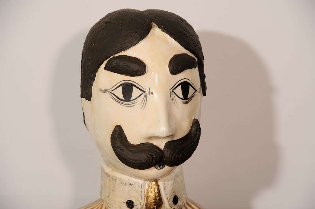 Papier mache bust of a 1960s dandy, painted in naturalistic colors with a gold-leafed cravat. Signed on the bottom by the sculptor.
