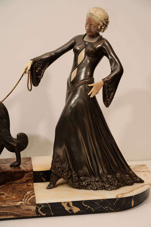 This bronze signed sculpture of a woman with two greyhounds rests on an exotic marble and alabaster inlayed base. Georges Gori was a pupil of Injalbert and exhibited in the late 1920s to 1939 at the Salon Des Artistes Francais winning nu merous