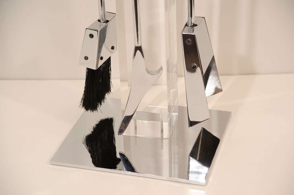 Lucite fire tool set with chromed<br />
base and bakelite handles.  Set<br />
is comprised of brush, ash pan, <br />
and poker.