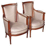 Pair antique French walnut Louis XVI upholstered bergeres.