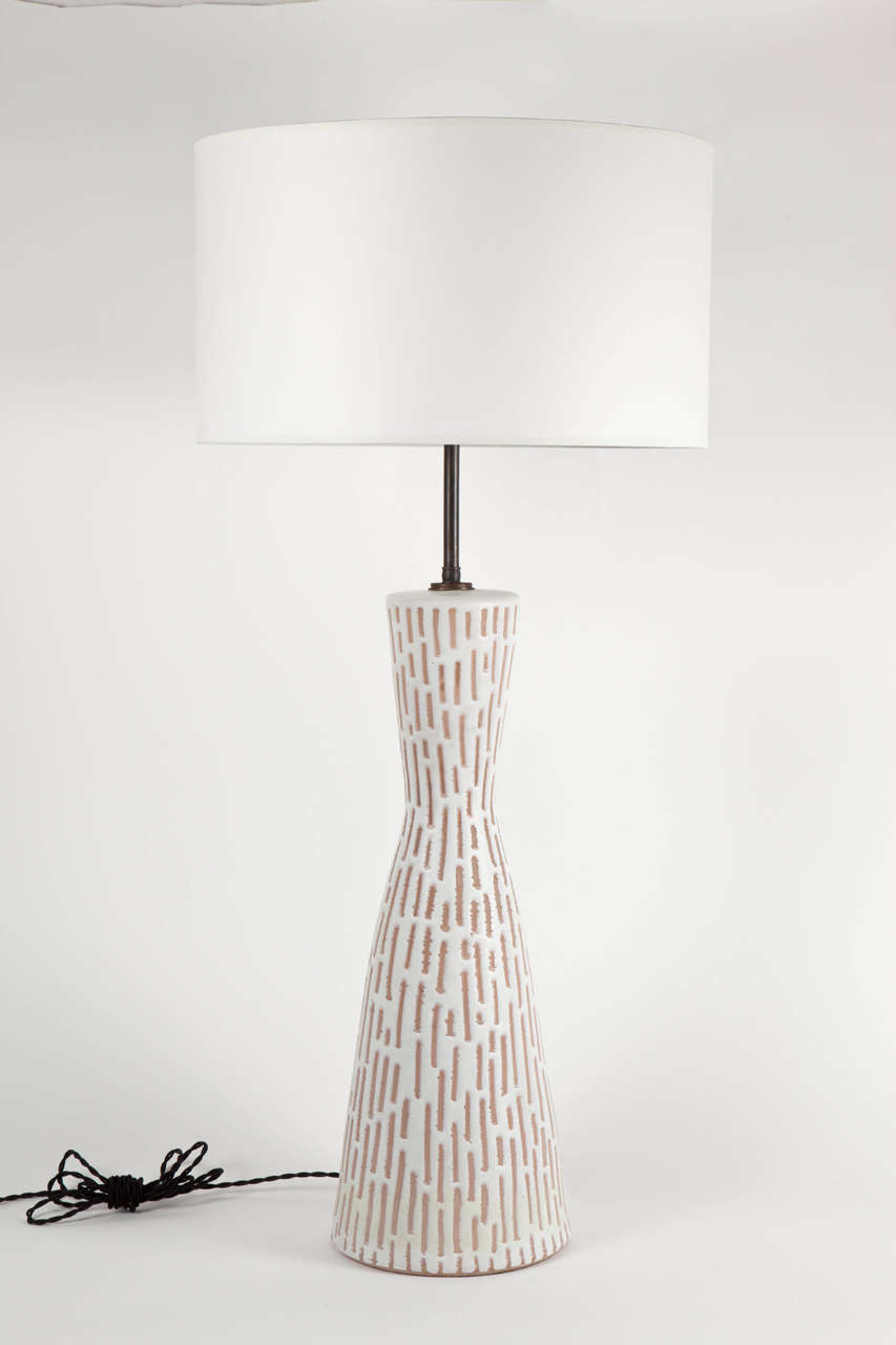 Ceramic table lamp by Raymor.  Signed.  Italy, circa 1960.  Features brown geometric shapes on a white background.

Dimensions:
35 inches overall height
21 inches base only height
7.5 inch base width
Shade 15
