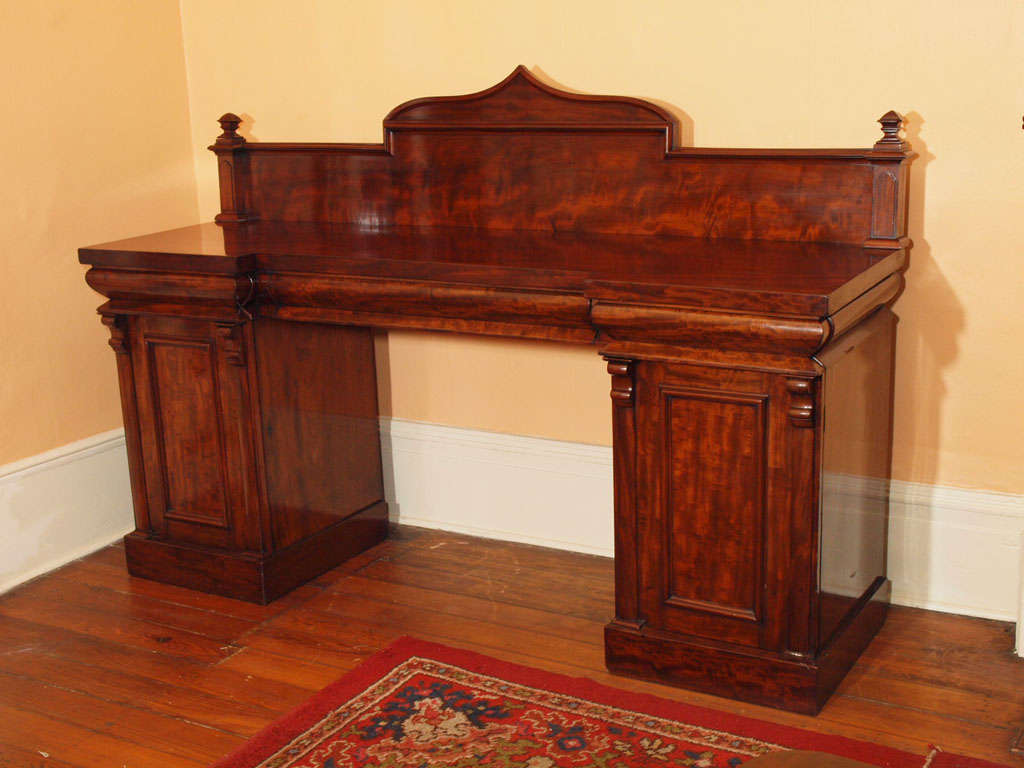 Antique English Regency flame mahogany pedestal sideboard.