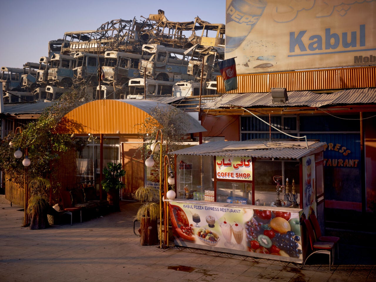 Simon Norfolk Color Photograph - Kabul 'Pizza Express' Restaurant Behind The Municipal Bus Depot
