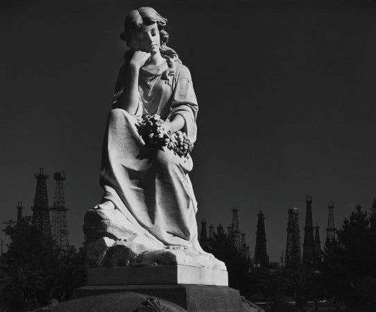 Ansel Adams Black and White Photograph - Cemetery Statue and Oil Derricks. Long Beach, CA 1939