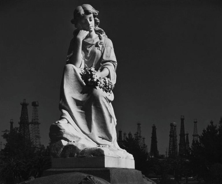 Ansel Adams - Cemetery Statue and Oil Derricks. Long Beach, CA 1939 For