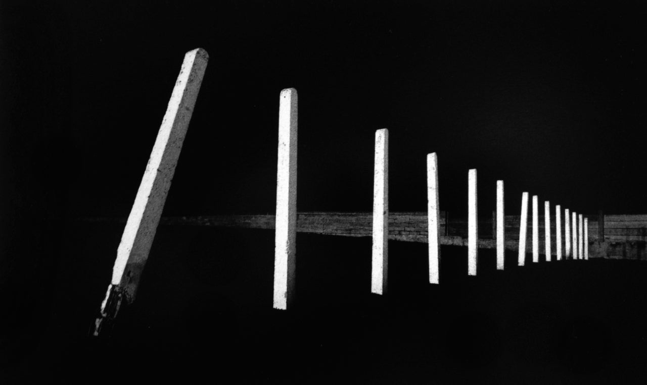 Michael Kenna Black and White Photograph - Tilted Poles, Rhyl, Clywd, Wales