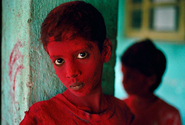 Red Boy, Bombay, India - Photograph by Steve McCurry