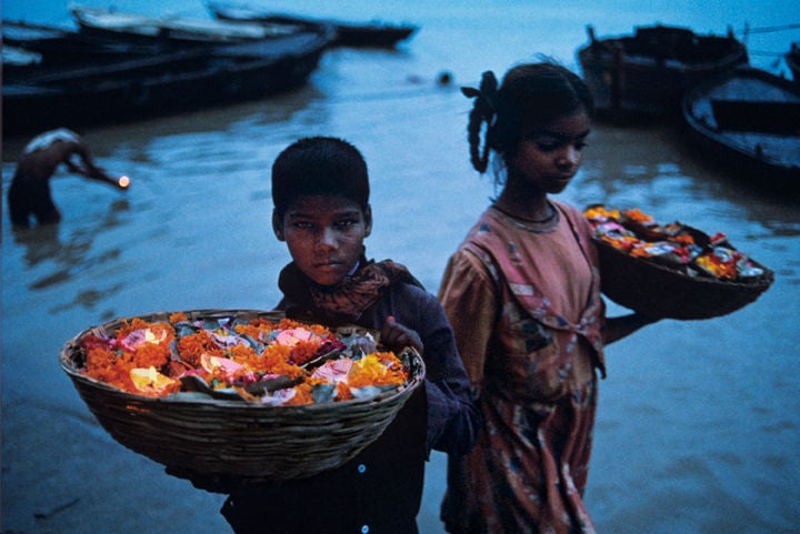 Floating Offerings, Varanasi, India - Photograph by Steve McCurry