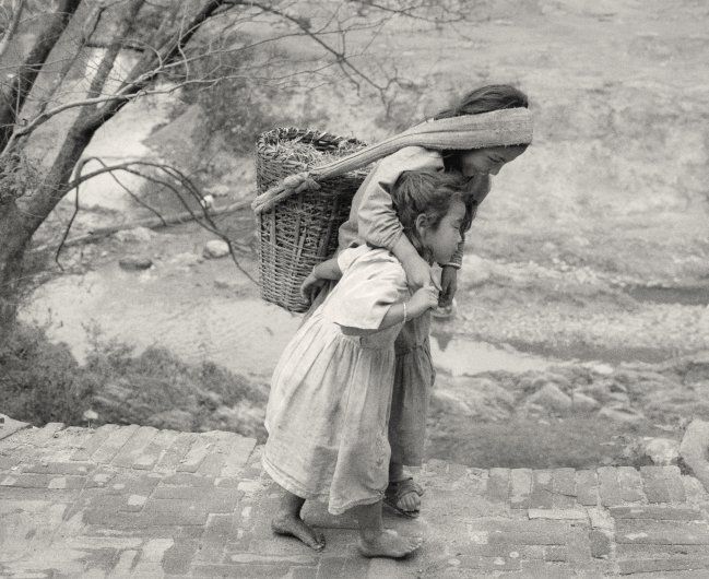 Panauti, Nepal (Boy and Girl with Basket) - Photograph by Pentti Sammallahti